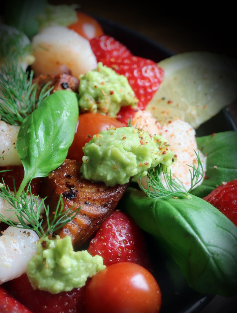 Delicious salmon salad with berreis, avocado and prawns. And lovely spice and herbs!